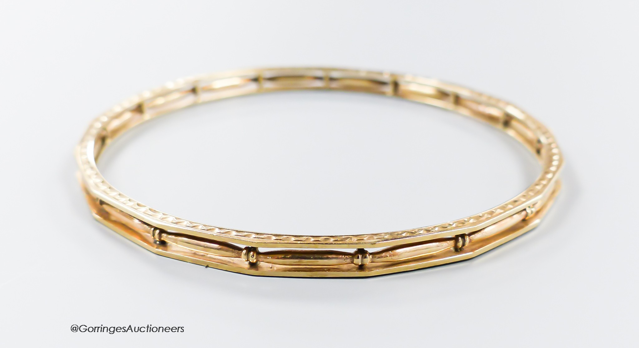 A pierced 9ct bangle, interior diameter 68mm, 13.2 grams.